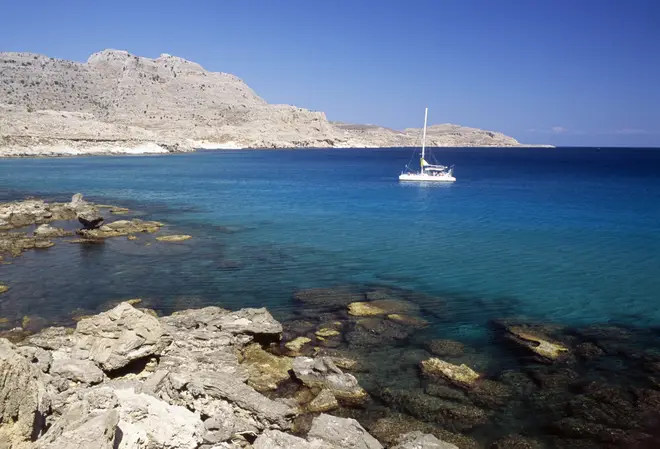 File photo of a boat sailing along the coast near Agia Agathi, Rhodes island, Greece.
