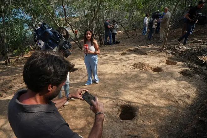 Members of the media gather at the dig site at Barragem do Arade reservoir, in the Algave, Portugal