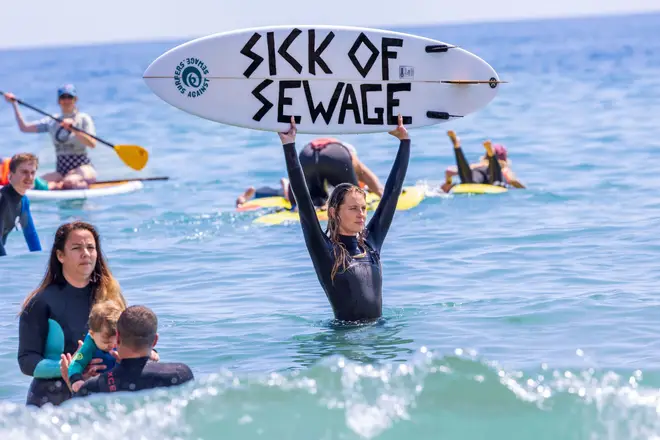 Protesters on Gylly Beach join thousands across the country in a paddle-out-protest against sewage pollution through a Surfers Against Sewage campaign.
