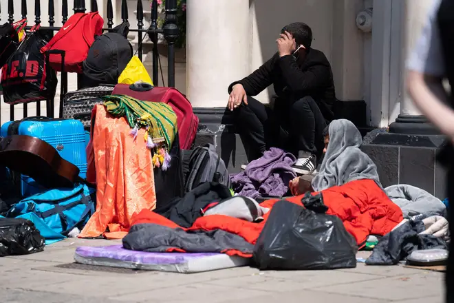 A scatter of sleeping bags and suitcases were seen on the pavement outside the hotel.