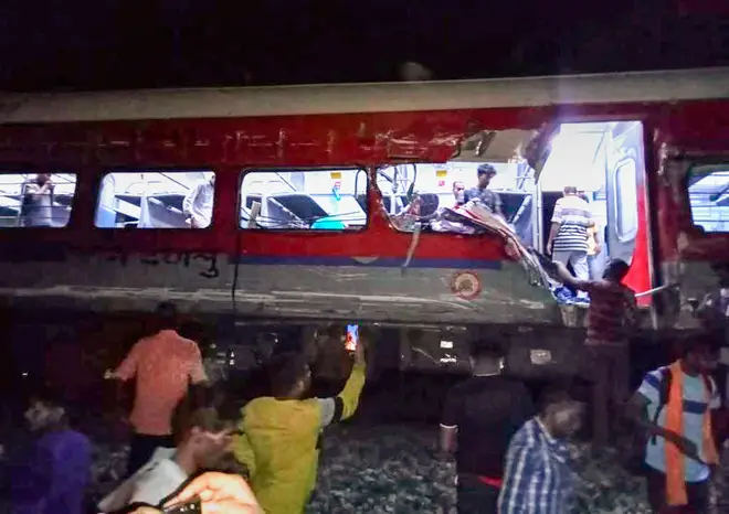 People inspected the site of passenger trains that derailed in Balasore district.