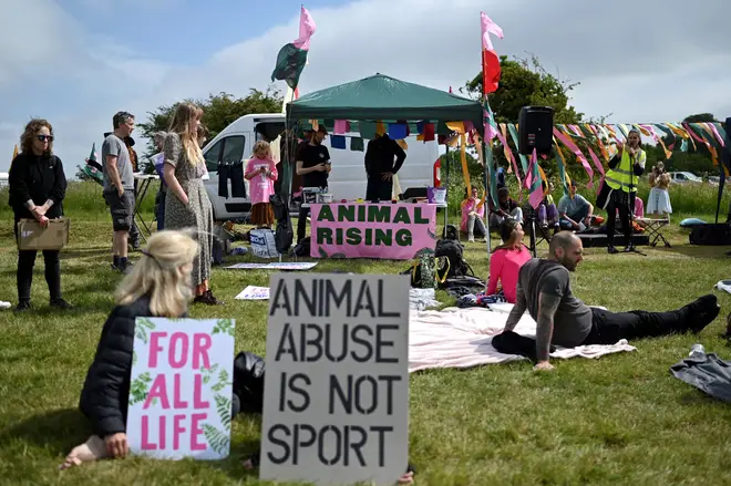 Animal Rising activists protest outside the main gates on the second day of the Epsom Derby Festival