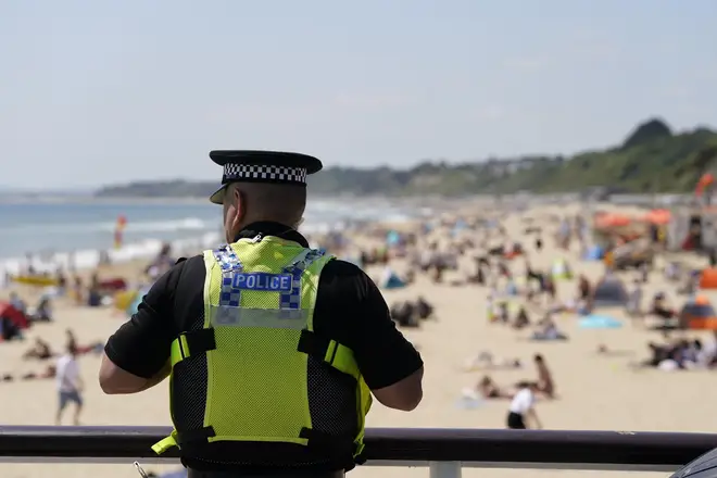 A police officer looks out over Bournemouth beach