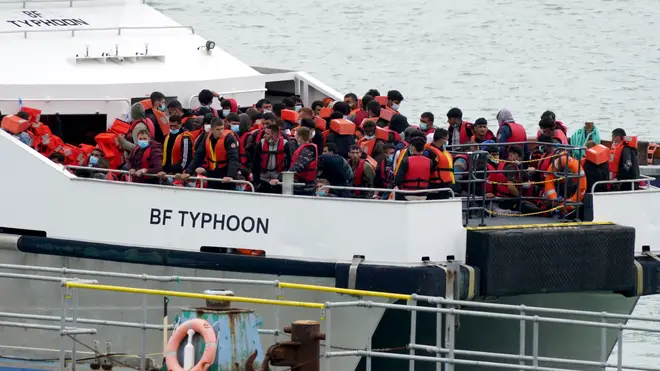 Immigrants are pictured being escorted to shore on a UK Border Force vessel after making the perilous journey across the Channel