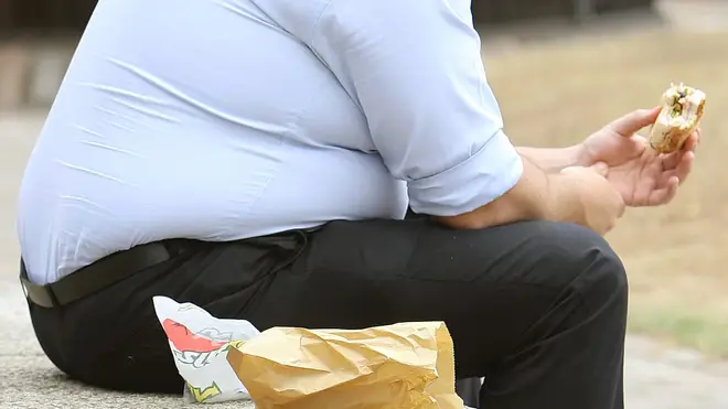 A large man eating lunch