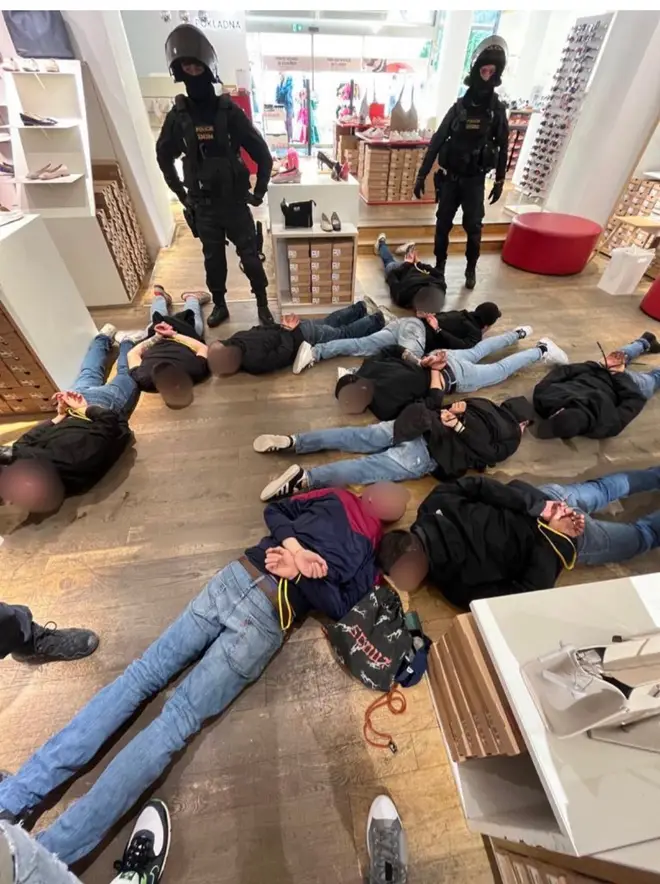 The Czech police shared a photo of officers overlooking a number of the attackers with their hands cuffed on the floor.