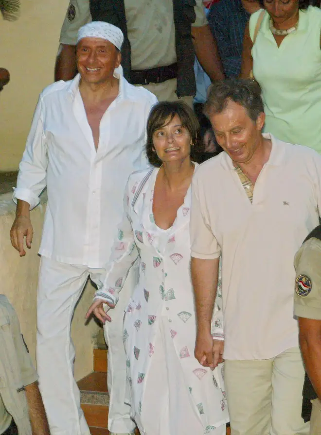 Silvio Berlusconi goes for a walk British Prime Minister Tony Blair, right, and his wife Cherie Blair, after their arrival at Berlusconi's luxury villa, in Porto Rotondo on the Island-region of Sardinia, Italy, Monday Aug. 16, 2004