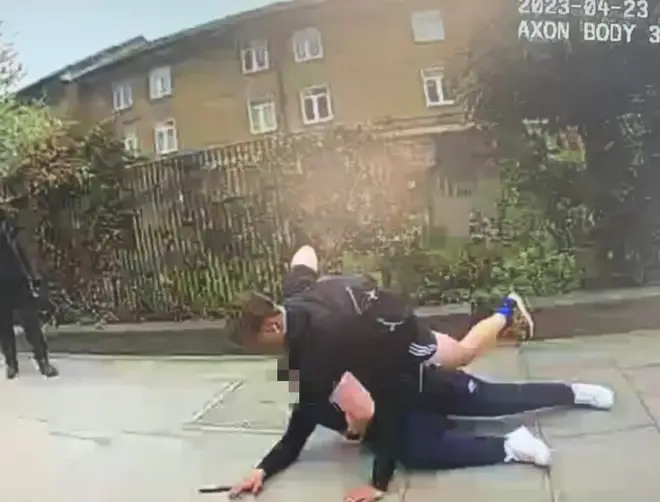 PC Fox detains the youth in the street in east London