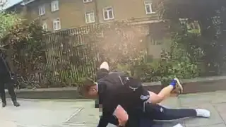 PC Fox detains the youth in the street in east London
