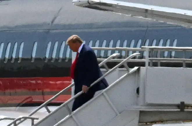 Former US President Donald Trump disembarks "Trump Force One" at Miami International Airport in Miami