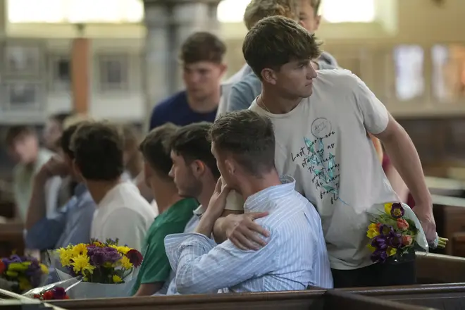Local residents comfort one another following Nottingham's attack