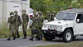 Members of Japan's Self Defence Force gather near the firing range after the fatal shooting