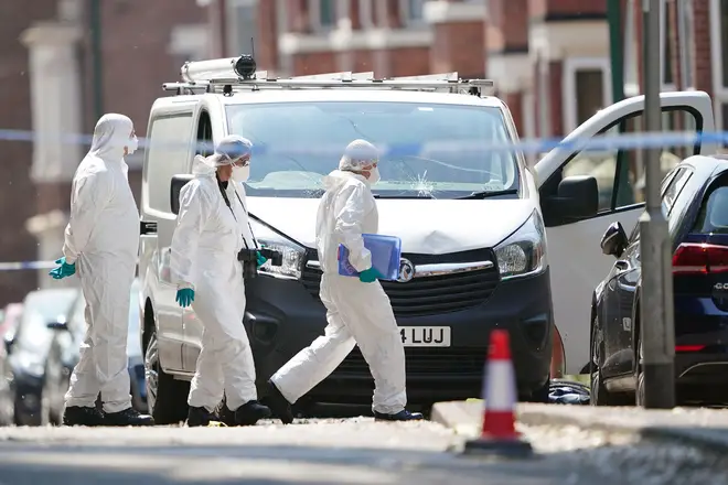 Forensics officers examine the van used in the attack yesterday
