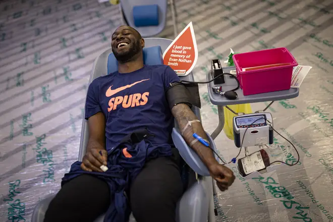 Former Tottenham Hotspur player Ledley King donates blood at a blood donation clinic