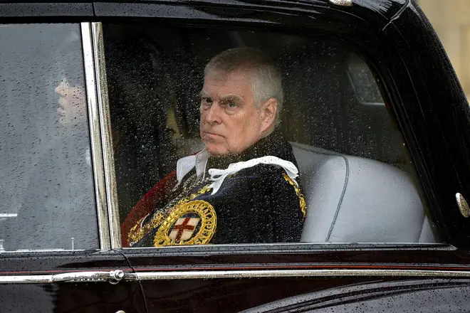 Prince Andrew in uniform while travelling in the back of a car
