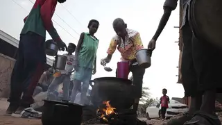 People prepare food in a Khartoum neighbourhood