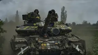 Ukrainian soldiers on a tank heading towards their positions near Bakhmut