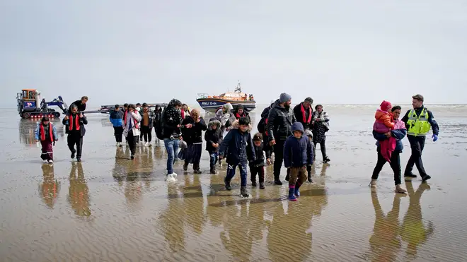 Channel migrants are pictured being taken onto shore by Border Force officials in May this year
