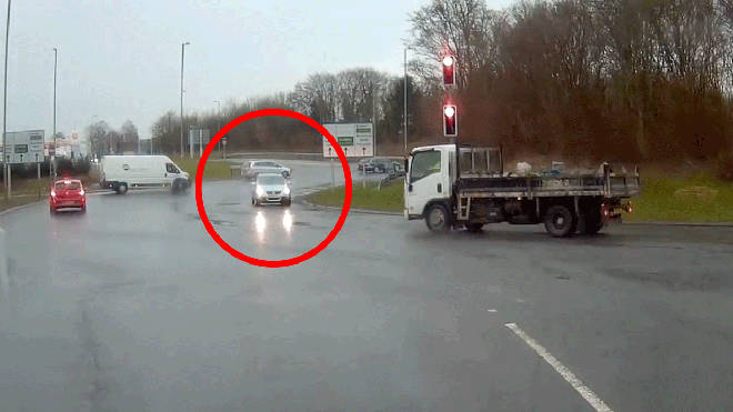 Hapless driver goes wrong way round a busy roundabout