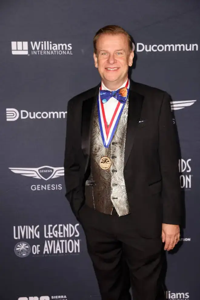 Hamish Harding wearing a medal and suit at a red carpet event