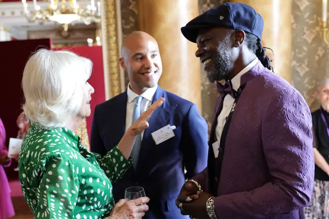 Queen Camilla speaks with Levi Roots during a reception at Buckingham Palace in London to celebrate the Windrush Generation