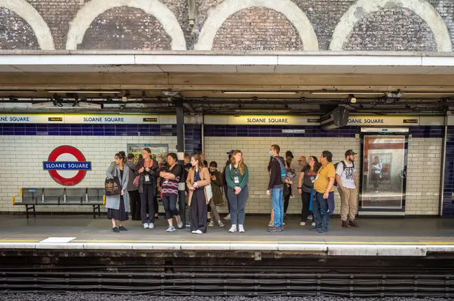 File photo of a group of people wait for for an underground train on the platform at Sloane Square