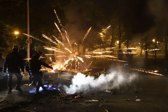 Police clear a street on the third night of protests sparked by the fatal police shooting of a 17-year-old driver in the Paris suburb of Nanterre, France