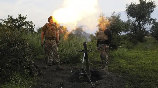 Ukrainian servicemen of fire an 82mm mortar towards Russian positions on the frontline near Bakhmut, Donetsk region