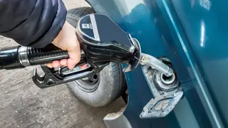 A driver fills up at a Tesco diesel pump