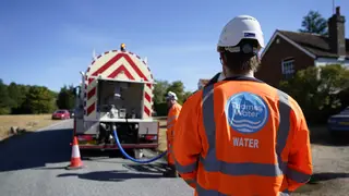 Thames Water workers deliver temporary supplies from a tanker