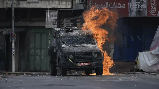 An Israeli armoured vehicle is targeted following a military raid in the West Bank city of Nablus