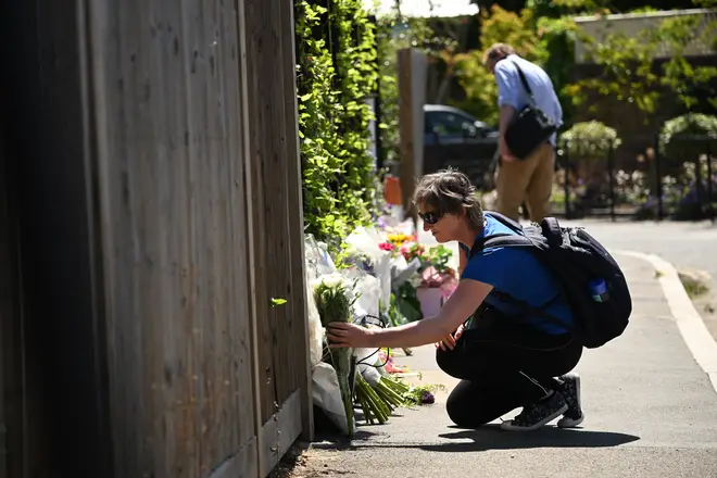 People have laid flowers in tribute to the victims of a car crash