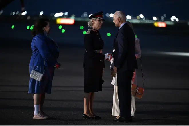 US President Joe Biden is greeted by Karen Pierce, the British Ambassador to the United States (L), and Jennifer Tolhurst, Lord-Lieutenant of Essex