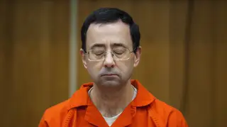 Larry Nassar sits with eyes closed during sentencing