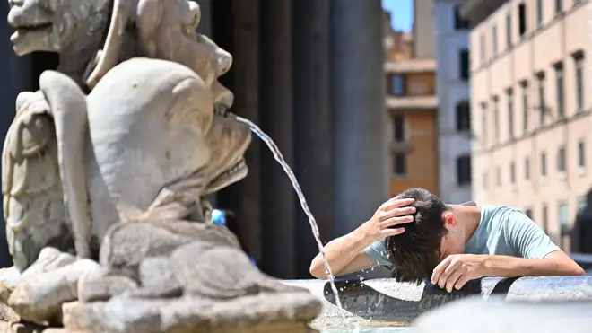 A boy refreshes himself at the Piazza della Rotonda fountain in Rome