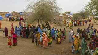 Displaced people gather at a refugee camp near El-Fashir in the Darfur region of Sudan