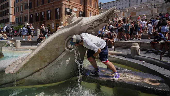 People cool off at Fontana della Barcaccia