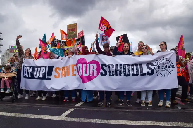 Protesters march with a 'Save our schools' banner during the demonstration on Westminster Bridge