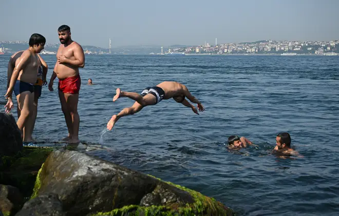 People jump into sea to cool off as the heatwave grips Istanbul