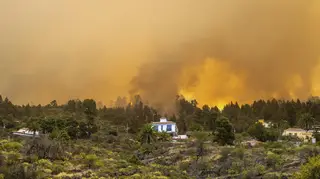 A burning forest fire close to homes near Puntagorda on the Canary Island of La Palma