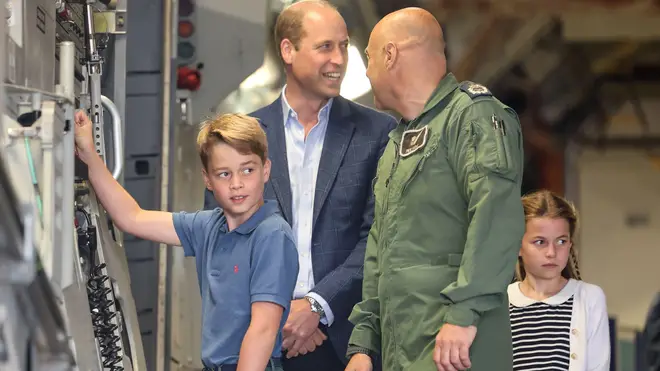 George is pictured alongside his father and an army officer abroad a military vehicle in recent weeks