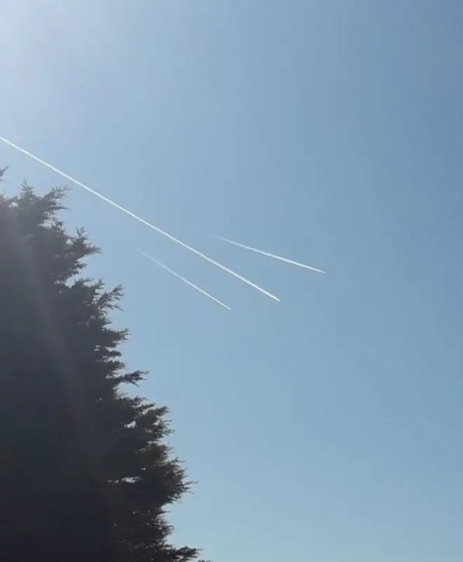 The plane being escorted by two RAF Typhoons