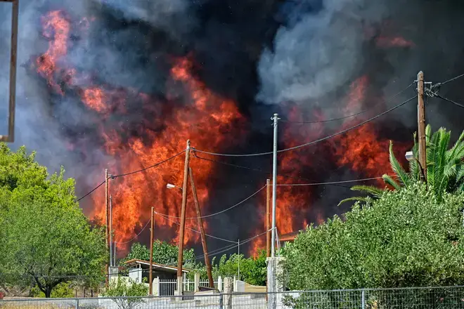 Firefighters battle blaze in Loutraki, Greece as Europe's temperatures soar.