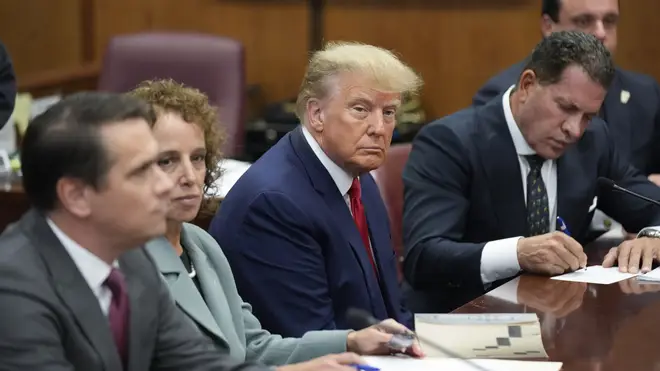 Donald Trump sits at the defence table with his legal team in a Manhattan court