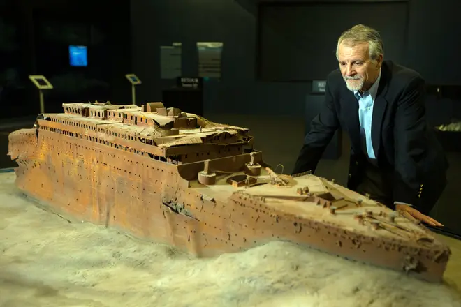 Paul-Henri Nargeolet, director of a deep ocean research project dedicated to the Titanic, poses next to a miniature version of the sunken ship in 2013