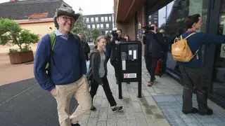Climate activist Greta Thunberg, centre, arrives at court