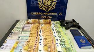 Money, weapons and documents seized in a raid