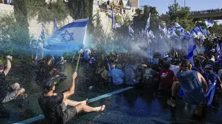 Israeli police in Jerusalem use a water cannon to disperse demonstrators blocking a road during a protest against plans by Prime Minister Benjamin Netanyahu’s government to overhaul the judicial syste