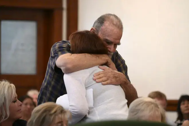 Kay and Larry Woodcock, the grandparents of JJ Vallow, embrace each other after Lori gave her victim impact statement