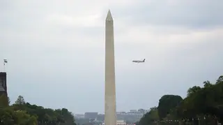 Donald Trump’s plane flies behind the Washington Monument as it makes its final approach into Reagan National Airport